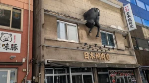 壁に突進する牛？遊び心が光る立体看板